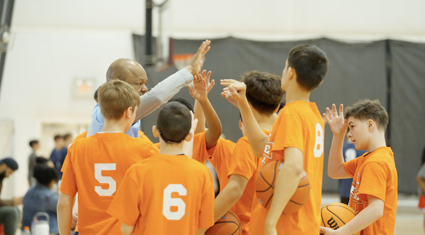 CT Elite coach giving high fives to young players in orange jerseys during a Home Court practice