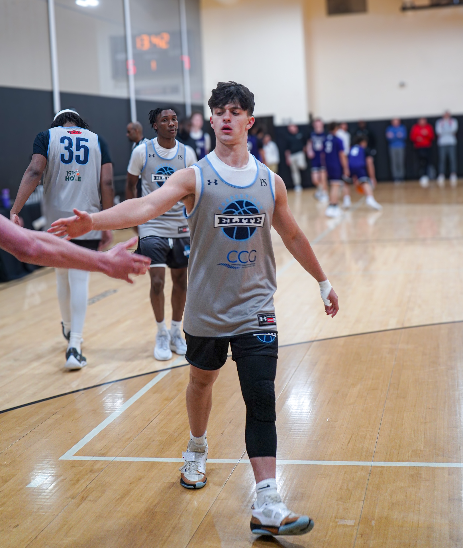 CT Elite player giving a teammate a high-five during a game